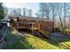 Spacious deck with stairs leading to a patio and fire pit at 132 30Th Nw Ave, Hickory, NC 28601