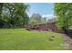 Expansive backyard featuring a well-maintained lawn, mature trees, and a deck with access steps at 132 30Th Nw Ave, Hickory, NC 28601