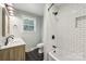 Updated bathroom with modern fixtures, subway tile shower, and black-and-white hexagon tile flooring at 132 30Th Nw Ave, Hickory, NC 28601