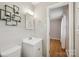 This bathroom features a white vanity sink with a decorative metal wall decoration and lighting at 132 30Th Nw Ave, Hickory, NC 28601