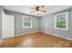Neutral bedroom with hardwood floors, two windows, and a ceiling fan at 132 30Th Nw Ave, Hickory, NC 28601