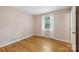 Simple bedroom with hardwood floors, one window, and a neutral color scheme at 132 30Th Nw Ave, Hickory, NC 28601