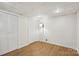 The bedroom features hardwood floors, recessed lighting, and white double-door closets for storage at 132 30Th Nw Ave, Hickory, NC 28601