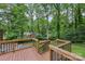 Wooden deck with black railings overlooking a lush backyard, perfect for outdoor relaxation and entertainment at 132 30Th Nw Ave, Hickory, NC 28601