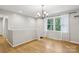 Bright dining room with hardwood floors, large window, and traditional chandelier at 132 30Th Nw Ave, Hickory, NC 28601