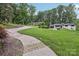 Long driveway that ascends to the home, with a well-kept lawn and mature trees at 132 30Th Nw Ave, Hickory, NC 28601