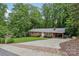 Traditional brick home featuring a covered parking area and brick-trimmed concrete driveway at 132 30Th Nw Ave, Hickory, NC 28601