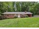 Charming brick ranch-style home with a well-manicured lawn and mature trees at 132 30Th Nw Ave, Hickory, NC 28601