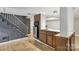 The kitchenette features wood cabinets and a tile countertop near the stairway to the basement at 132 30Th Nw Ave, Hickory, NC 28601