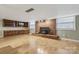 This living room features a brick fireplace with a wood burning stove and cabinets at 132 30Th Nw Ave, Hickory, NC 28601