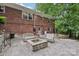 A stone patio with a brick fire pit and bench seating is perfect for entertaining al fresco at 132 30Th Nw Ave, Hickory, NC 28601