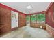 Enclosed patio with brick walls and a door leading to the backyard at 132 30Th Nw Ave, Hickory, NC 28601