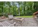 Brick fire pit, stone patio with benches, and natural landscaping for outdoor gatherings and relaxation at 132 30Th Nw Ave, Hickory, NC 28601