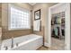 Bathroom with a soaking tub, tile flooring and walk-in closet at 157 Highland Forest Dr, Clover, SC 29710