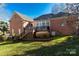 Home's back elevation, showcasing a deck and sunroom at 157 Highland Forest Dr, Clover, SC 29710