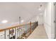 Upstairs hallway with wood railing and carpet at 157 Highland Forest Dr, Clover, SC 29710