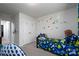 bedroom with dinosaur theme, twin bed, and ample closet space at 18106 Pear Hawthorne Dr, Huntersville, NC 28078