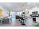 Modern kitchen with white cabinets and large island open to living area at 18106 Pear Hawthorne Dr, Huntersville, NC 28078