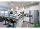 Open concept kitchen with island, stainless steel appliances, and hardwood floors at 18106 Pear Hawthorne Dr, Huntersville, NC 28078
