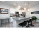 Modern kitchen with white cabinets, granite island, and stainless steel appliances at 18106 Pear Hawthorne Dr, Huntersville, NC 28078