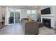 Living room with sectional sofa, fireplace, and sliding glass door to patio at 18106 Pear Hawthorne Dr, Huntersville, NC 28078