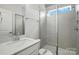 Modern bathroom featuring a glass-enclosed shower, sleek vanity, and neutral tile at 2024 Embassy Ct # 49, Charlotte, NC 28213