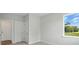Cozy bedroom with neutral walls, carpet, and a window with a peaceful outdoor view at 2024 Embassy Ct # 49, Charlotte, NC 28213
