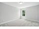 Bedroom featuring plush carpet and a sunlit window at 2024 Embassy Ct # 49, Charlotte, NC 28213