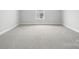 Expansive bedroom showcasing neutral carpeting and a large window at 2024 Embassy Ct # 49, Charlotte, NC 28213