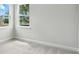 Bright bedroom with carpet flooring and plenty of natural light from multiple windows at 2024 Embassy Ct # 49, Charlotte, NC 28213