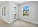 Bedroom with two windows and a door to a balcony providing light at 2024 Embassy Ct # 49, Charlotte, NC 28213