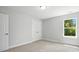 Bedroom with natural light, closet doors, and neutral carpeting at 2024 Embassy Ct # 49, Charlotte, NC 28213