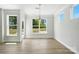 Light-filled dining area showcasing hardwood floors, large windows, and modern fixtures at 2024 Embassy Ct # 49, Charlotte, NC 28213
