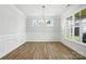 Elegant dining room with wainscoting, hardwood floors, and a modern chandelier at 2024 Embassy Ct # 49, Charlotte, NC 28213