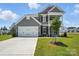 Gray two-story home featuring a well-maintained lawn and attached two-car garage at 2024 Embassy Ct # 49, Charlotte, NC 28213