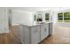 Open-concept kitchen island with stainless steel appliances and views of the fireplace at 2024 Embassy Ct # 49, Charlotte, NC 28213