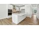 Bright kitchen featuring white cabinets, stainless steel appliances, and hardwood floors at 2024 Embassy Ct # 49, Charlotte, NC 28213