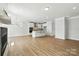 Open-concept living room with a fireplace and modern kitchen island, providing an ideal layout at 2024 Embassy Ct # 49, Charlotte, NC 28213