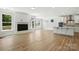 Bright, open living room with fireplace and modern kitchen island with white cabinets at 2024 Embassy Ct # 49, Charlotte, NC 28213
