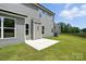 A concrete patio with large sliding door offers outdoor living space and enhances the home's appeal at 2024 Embassy Ct # 49, Charlotte, NC 28213