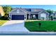 Charming single-story home boasts a dark garage, stone accents, and well-manicured lawn at 3100 Glacier Ct, Gastonia, NC 28056