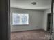 Bright bedroom with neutral carpeting and large window at 3508 Colony Rd # H, Charlotte, NC 28211