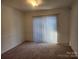 Spacious dining room with carpeted floor and sliding door at 3508 Colony Rd # H, Charlotte, NC 28211