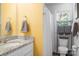 Bathroom with yellow walls, granite countertop, and shower at 506 Broadway Ct # 9, Statesville, NC 28677