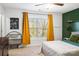 Spacious bedroom with large window and mustard curtains at 506 Broadway Ct # 9, Statesville, NC 28677