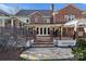 Brick home with spacious deck, stone patio, pergola, and steps leading to the yard at 5401 Sunningdale Dr, Charlotte, NC 28277