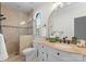 Bathroom with beige tile, white vanity and arched window at 5401 Sunningdale Dr, Charlotte, NC 28277