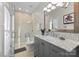 Modern bathroom with gray vanity, marble countertops and walk-in shower at 5401 Sunningdale Dr, Charlotte, NC 28277