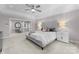 Main bedroom with gray upholstered bed and sitting area at 5401 Sunningdale Dr, Charlotte, NC 28277