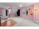 Charming bedroom with pink walls and wood floor at 5401 Sunningdale Dr, Charlotte, NC 28277